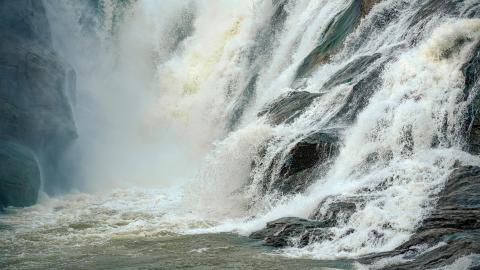 Scenic Waterfall Surrounded by Lush Greenery